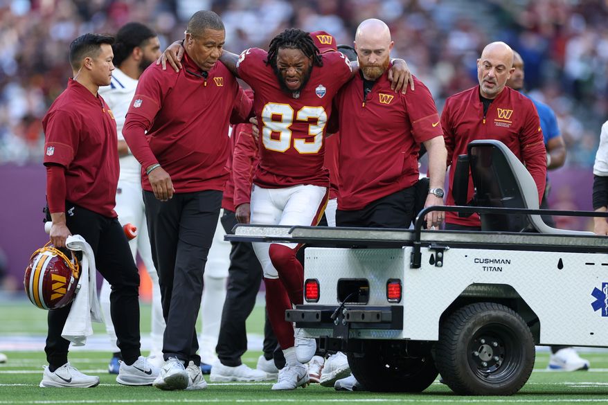 Washington Commanders wide receiver Jaylin Lane (83) is taken from the field injured during an NFL football game against Indianapolis Colts in London, Sunday, Oct. 4, 2026. (AP Photo/Ian Walton)