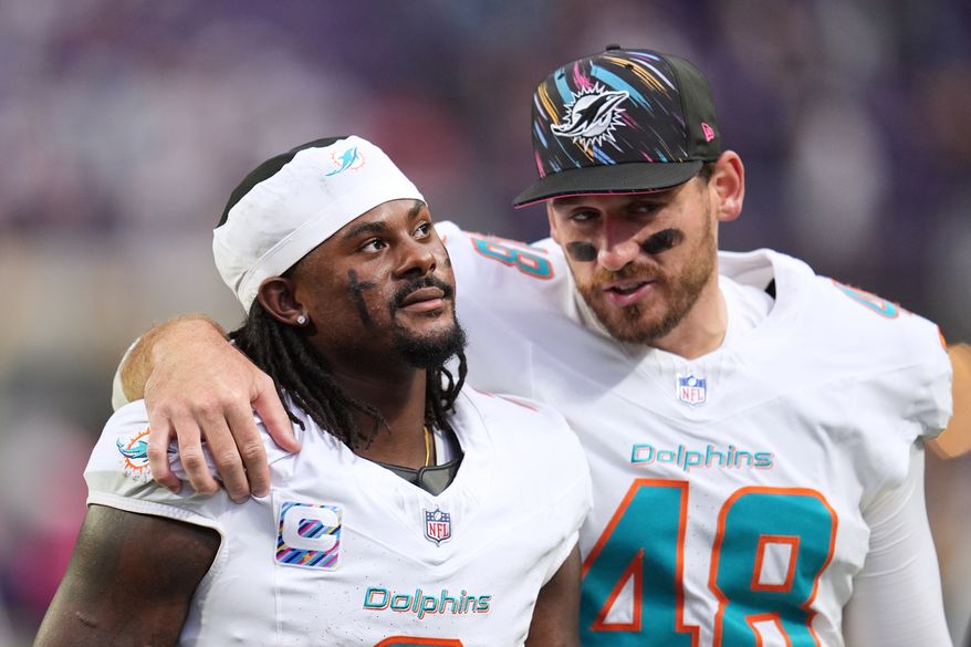 Miami Dolphins quarterback Malik Willis, left, and punter Bradley Pinion leave the field following an NFL football game against the Minnesota Vikings, Sunday, Oct. 4, 2026, in Minneapolis. (AP Photo/Abbie Parr)