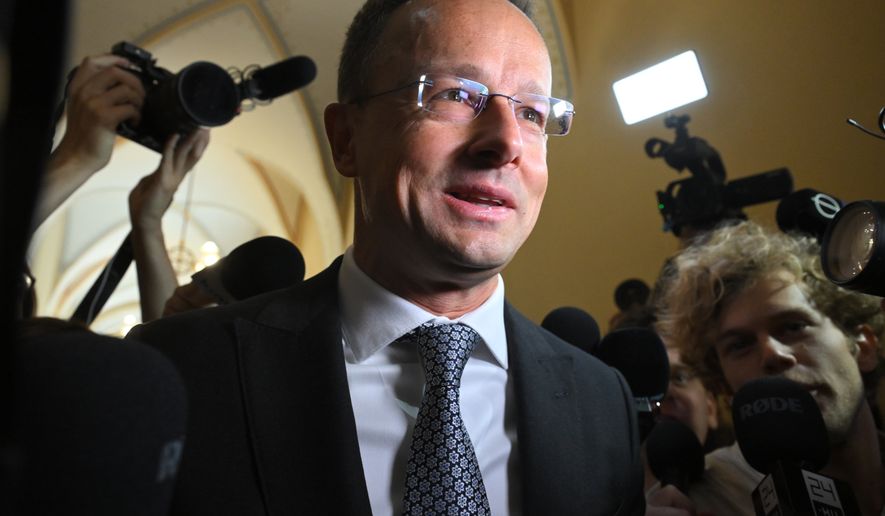 Former Hungarian Minister of Foreign Affairs and Trade Peter Szijjarto talks to the press as he arrives for a closed-door hearing by the National Security Committee of the National Assembly in the parliament building in Budapest, Hungary, Monday, Oct. 5, 2026. (Noemi Bruzak/MTI via AP)