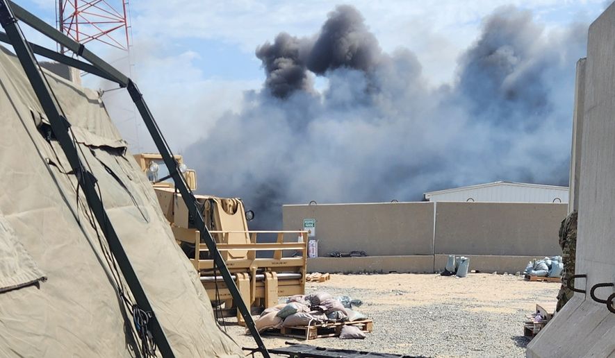 In this photo obtained by The Associated Press, smoke rises from an Iranian drone strike at Port Shuaiba in Kuwait on March 1, 2026, which killed multiple U.S. soldiers and injured dozens more. (AP Photo)