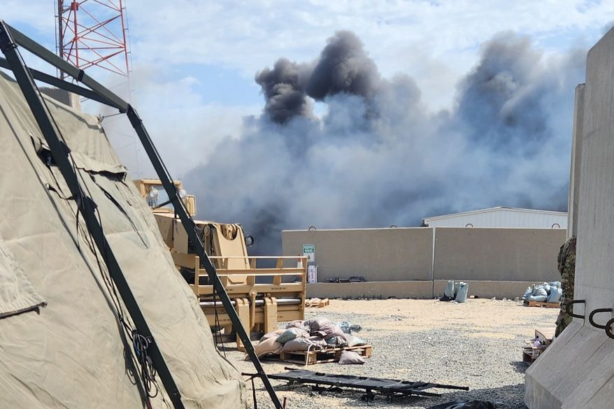 In this photo obtained by The Associated Press, smoke rises from an Iranian drone strike at Port Shuaiba in Kuwait on March 1, 2026, which killed multiple U.S. soldiers and injured dozens more. (AP Photo)