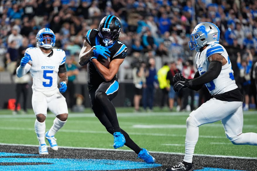 Carolina Panthers wide receiver Tetairoa McMillan (4) scores a touchdown during an NFL football game against the Detroit Lions in Charlotte, N.C., Sunday, Oct. 4, 2026. (AP Photo/Erik Verduzco)
