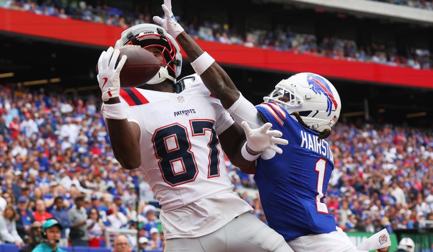 New England Patriots wide receiver Romeo Doubs (87) makes a catch for a touchdown against Buffalo Bills cornerback Maxwell Hairston (1) in the second half during an NFL football game in Orchard Park, N.Y., Sunday, Oct. 4, 2026. (AP Photo/Jeffrey T. Barnes)