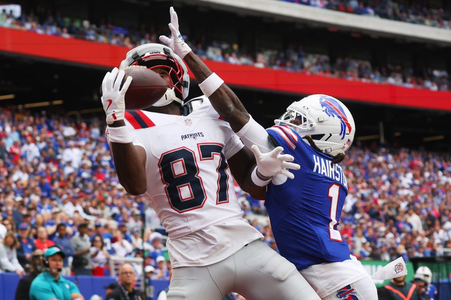 New England Patriots wide receiver Romeo Doubs (87) makes a catch for a touchdown against Buffalo Bills cornerback Maxwell Hairston (1) in the second half during an NFL football game in Orchard Park, N.Y., Sunday, Oct. 4, 2026. (AP Photo/Jeffrey T. Barnes)