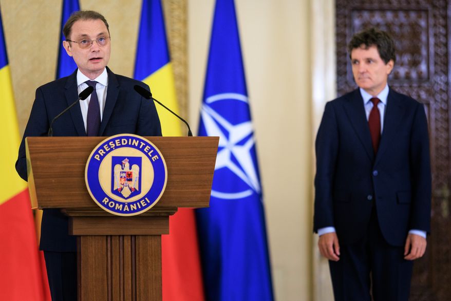 Romanian Prime Minister designate Luca Niculescu, left, speaks to media after being nominated to form a government by Romanian President Nicusor Dan, right, at the Cotroceni Presidential Palace in Bucharest, Romania, Monday, Oct. 5, 2026. (AP Photo/Alexandru Nechez)