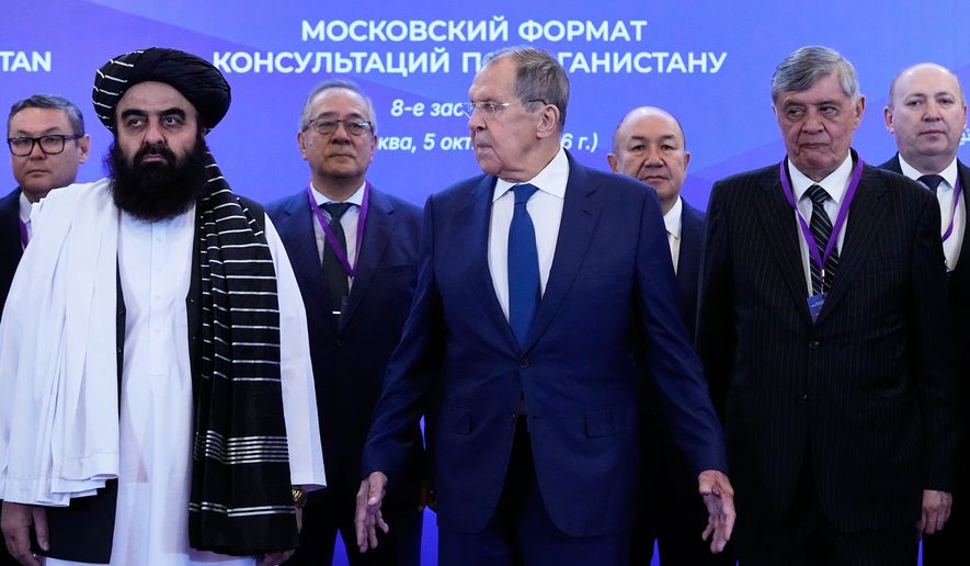 Front, from left, Afghanistan's Foreign Minister Amir Khan Muttaqi, Russian Foreign Minister Sergey Lavrov and Russian Presidential Envoy to Afghanistan Zamir Kabulov pose for a photo ahead of the Moscow format consultations on Afghanistan in Moscow, Monday, Oct. 5, 2026. (AP Photo/Alexander Zemlianichenko)