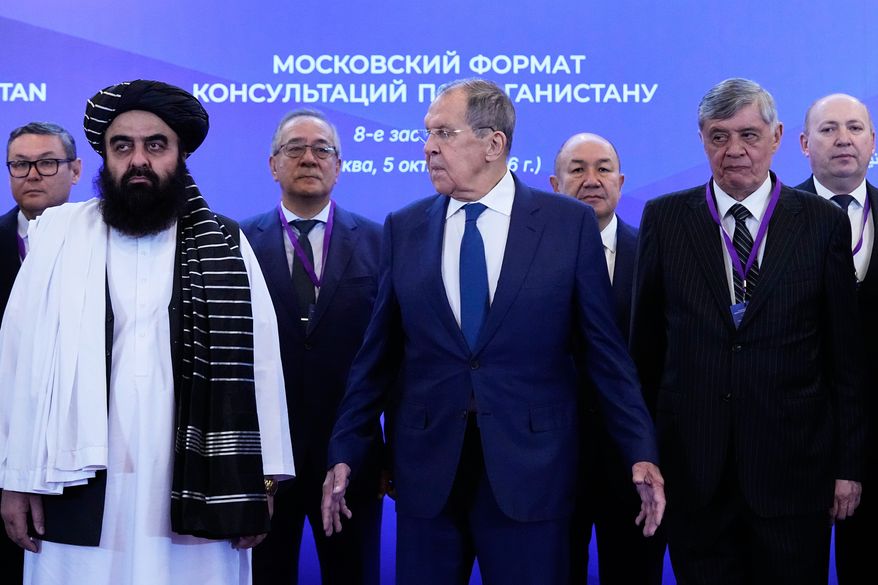 Front, from left, Afghanistan's Foreign Minister Amir Khan Muttaqi, Russian Foreign Minister Sergey Lavrov and Russian Presidential Envoy to Afghanistan Zamir Kabulov pose for a photo ahead of the Moscow format consultations on Afghanistan in Moscow, Monday, Oct. 5, 2026. (AP Photo/Alexander Zemlianichenko)