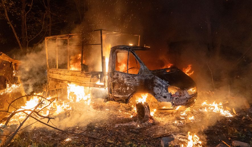 A car burns after a Russian drone strike on a residential neighborhood in Kharkiv, Ukraine, Sunday, Oct. 4, 2026. (AP Photo/Andrii Marienko)