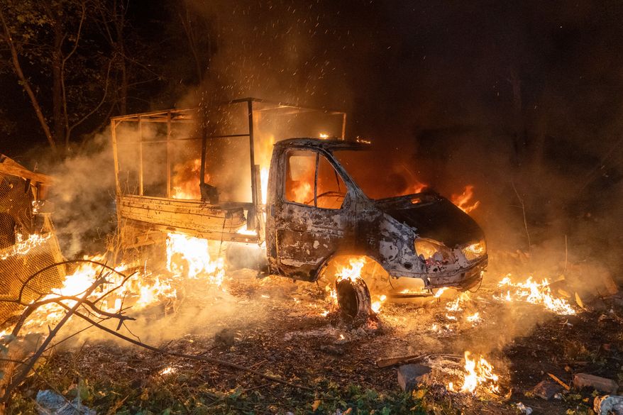 A car burns after a Russian drone strike on a residential neighborhood in Kharkiv, Ukraine, Sunday, Oct. 4, 2026. (AP Photo/Andrii Marienko)