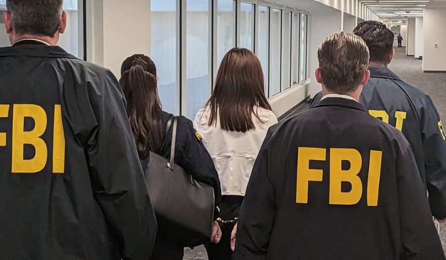 This photo provided by the Federal Bureau of Investigation shows Wanying Zhang being arrested Sunday, Oct. 4, 2026, in Los Angeles. (Federal Bureau of Investigation via AP)