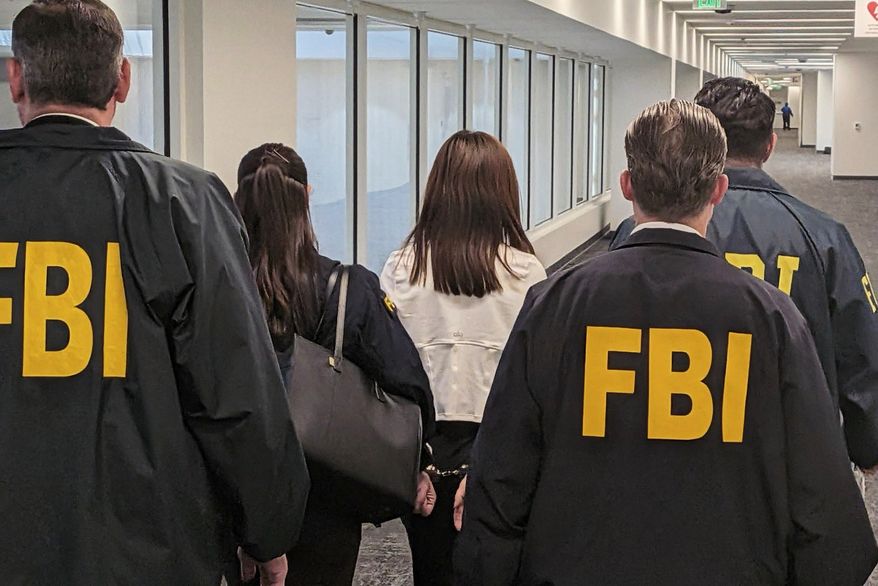 This photo provided by the Federal Bureau of Investigation shows Wanying Zhang being arrested Sunday, Oct. 4, 2026, in Los Angeles. (Federal Bureau of Investigation via AP)