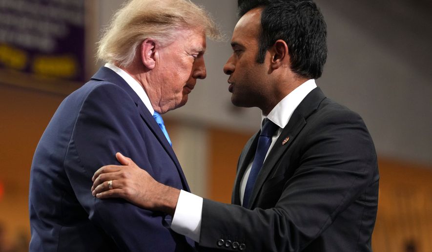 Ohio Republican gubernatorial candidate Vivek Ramaswamy, right, shakes the hand of President Donald Trump after speaking during an event at Butler High School in Vandalia, Ohio, Saturday, Oct. 3, 2026. (AP Photo/Mark Schiefelbein)