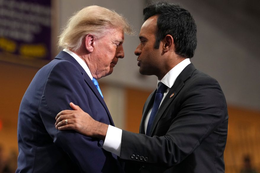 Ohio Republican gubernatorial candidate Vivek Ramaswamy, right, shakes the hand of President Donald Trump after speaking during an event at Butler High School in Vandalia, Ohio, Saturday, Oct. 3, 2026. (AP Photo/Mark Schiefelbein)