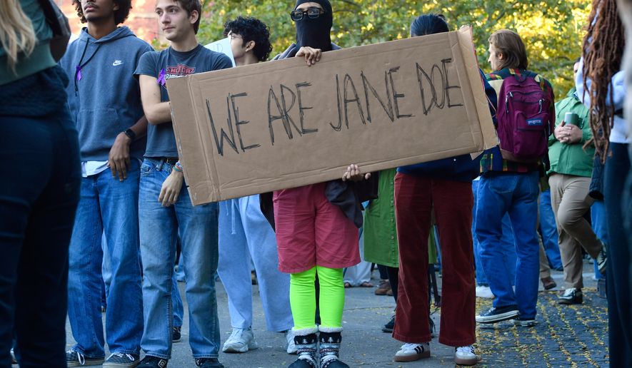 A demonstrator holds a sign reading "WE ARE JANE DOE" during a protest against Cornell University's handling of the 2024 fraternity-house gang rape allegations at the campus, Monday, Oct. 5, 2026, in Ithaca, N.Y. (AP Photo/Adrian Kraus)