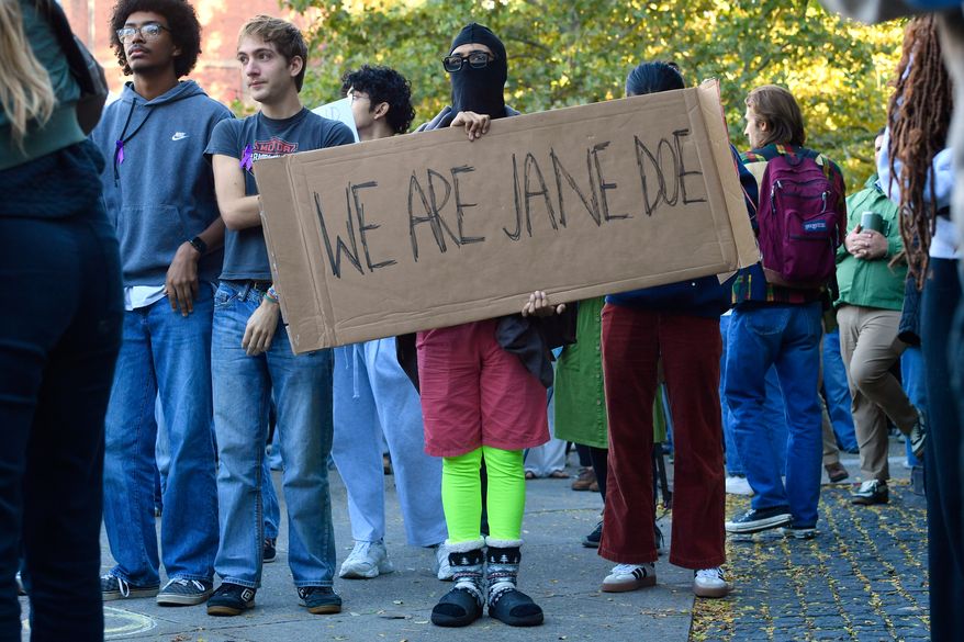 A demonstrator holds a sign reading "WE ARE JANE DOE" during a protest against Cornell University's handling of the 2024 fraternity-house gang rape allegations at the campus, Monday, Oct. 5, 2026, in Ithaca, N.Y. (AP Photo/Adrian Kraus)