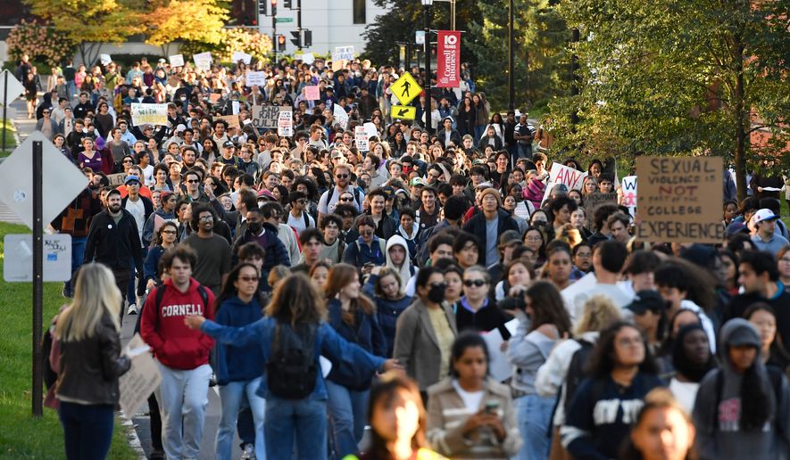Demonstrators march during a protest against Cornell University's handling of the 2024 fraternity-house gang rape allegations at the campus, Monday, Oct. 5, 2026, in Ithaca, N.Y. (AP Photo/Adrian Kraus)
