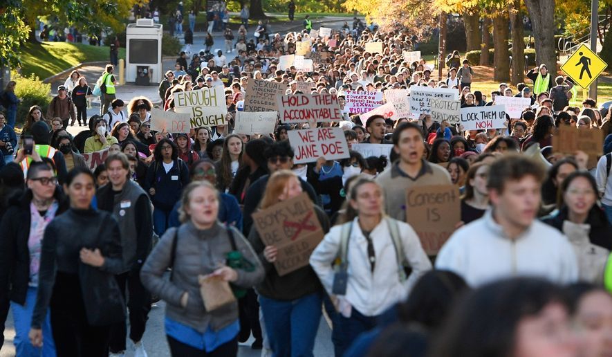 Demonstrators march during a protest against Cornell University's handling of the 2024 fraternity-house gang rape allegations at the campus, Monday, Oct. 5, 2026, in Ithaca, N.Y. (AP Photo/Adrian Kraus)