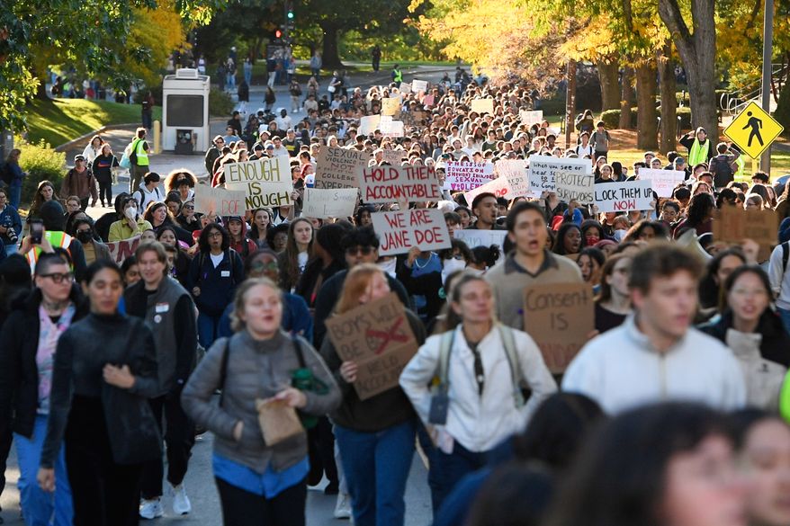 Demonstrators march during a protest against Cornell University's handling of the 2024 fraternity-house gang rape allegations at the campus, Monday, Oct. 5, 2026, in Ithaca, N.Y. (AP Photo/Adrian Kraus)