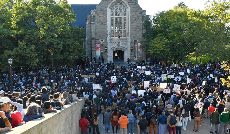 Demonstrators listen to a speaker during a protest against Cornell University's handling of the 2024 fraternity-house gang rape allegations at the campus, Monday, Oct. 5, 2026, in Ithaca, N.Y. (AP Photo/Adrian Kraus)