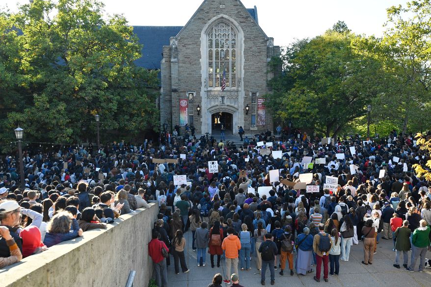Demonstrators listen to a speaker during a protest against Cornell University's handling of the 2024 fraternity-house gang rape allegations at the campus, Monday, Oct. 5, 2026, in Ithaca, N.Y. (AP Photo/Adrian Kraus)