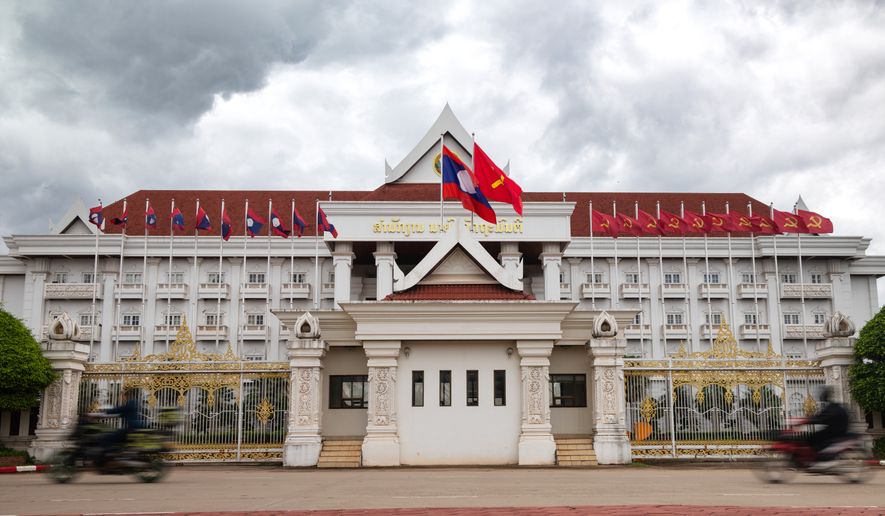 Motorists drive past a government building in Vientiane, Laos, on July 24, 2025. (AP Photo/Anton L. Delgado) ** FILE **