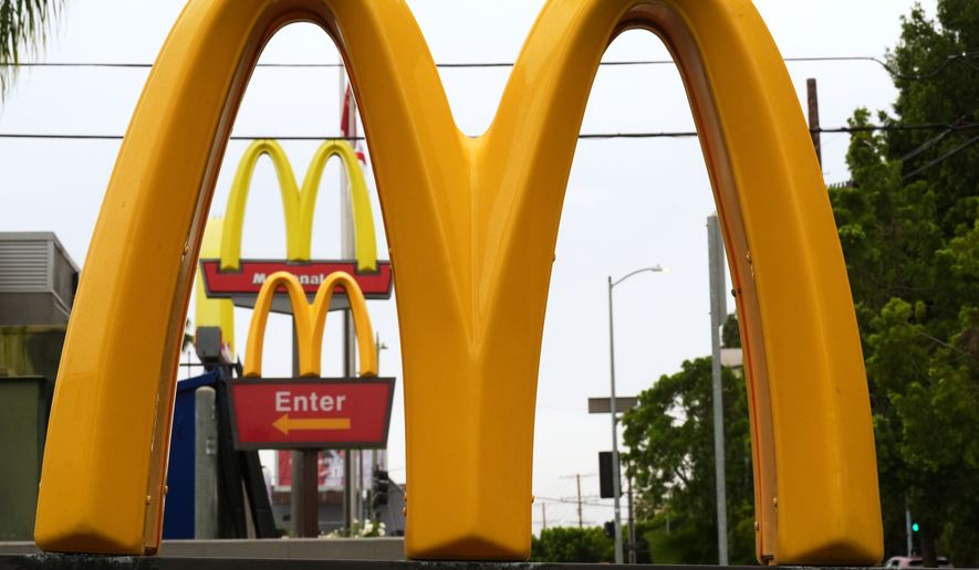 McDonald's Golden Arches signs are seen, March 31, 2026, in Los Angeles. (AP Photo/Damian Dovarganes, File)