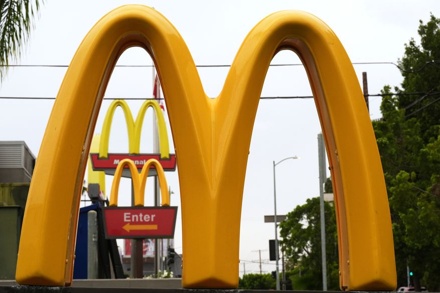 McDonald's Golden Arches signs are seen, March 31, 2026, in Los Angeles. (AP Photo/Damian Dovarganes, File)