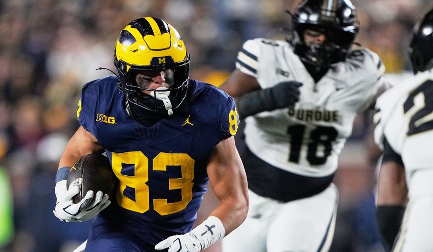 Michigan tight end Zack Marshall, left, runs during the second half of an NCAA college football game against Purdue, Nov. 1, 2025, in Ann Arbor, Mich. (AP Photo/Ryan Sun, File)