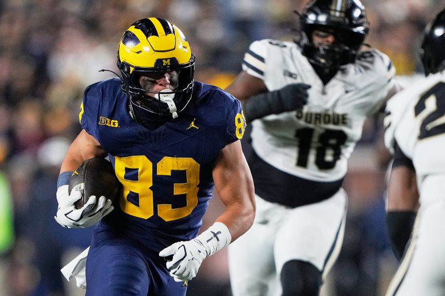 Michigan tight end Zack Marshall, left, runs during the second half of an NCAA college football game against Purdue, Nov. 1, 2025, in Ann Arbor, Mich. (AP Photo/Ryan Sun, File)
