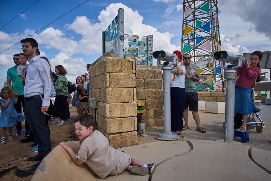 Visitors gather on a hill overlooking the Gaza Strip in Sderot, southern Israel, Thursday, Oct. 1, 2026. (AP Photo/Oded Balilty)