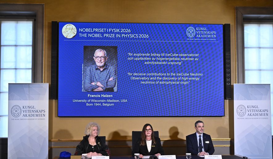 A portrait of Francis Halzen is shown on the screen as Eva Olsson, Ellen Moons, and Mark Pearce announce as the recipient of the 2026 Nobel Prize in Physics during a press conference at the Royal Swedish Academy of Sciences, Stockholm, Sweden, Oct. 6, 2026. (Christine Olsson/TT News Agency via AP)