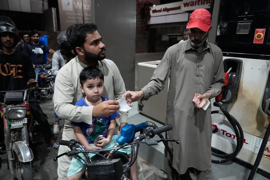 A motorcyclist gets fuel on subsidised rates in a recently government scheme for low income people, at a fuel station, in Lahore, Pakistan, Tuesday, Oct. 6, 2026. (AP Photo/K.M. Chaudary)