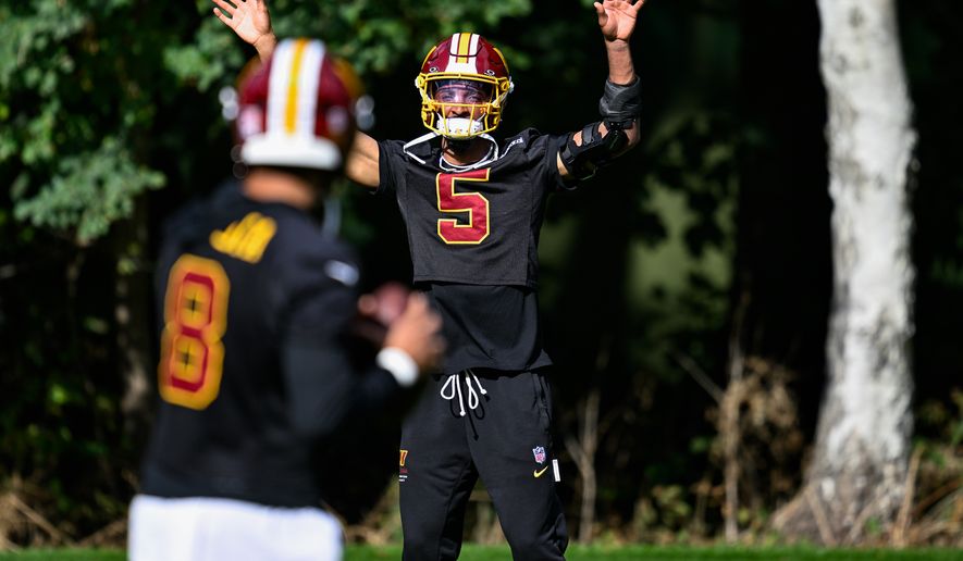 Washington Commanders quarterback Jayden Daniels (5) lets quarterback Marcus Mariota (8) know he’s open during practice at The Grove, Chandler’s Cross, Hertfordshire, England, October 2, 2026. (Photo by Brian Murphy for the Washington Times)