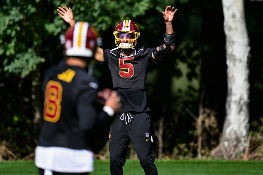 Washington Commanders quarterback Jayden Daniels (5) lets quarterback Marcus Mariota (8) know he’s open during practice at The Grove, Chandler’s Cross, Hertfordshire, England, October 2, 2026. (Photo by Brian Murphy for the Washington Times)