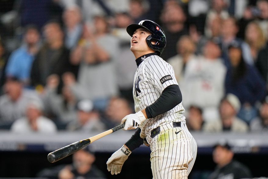 New York Yankees' Anthony Volpe follows through on a run-scoring double after a umpires review during the sixth inning in Game 3 of baseball's American League Division Series against the Tampa Bay Rays, Wednesday, Oct. 7, 2026, in New York. (AP Photo/Seth Wenig)