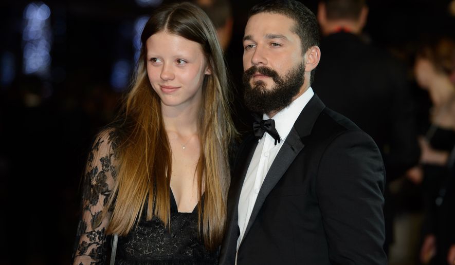 From left, Mia Goth and U.S actor Shia LaBeouf arrive for the premiere of Fury at a central London cinema, during the BFI London Film Festival, London, Sunday, Oct. 19, 2014. (Photo by Jonathan Short/Invision/AP)
