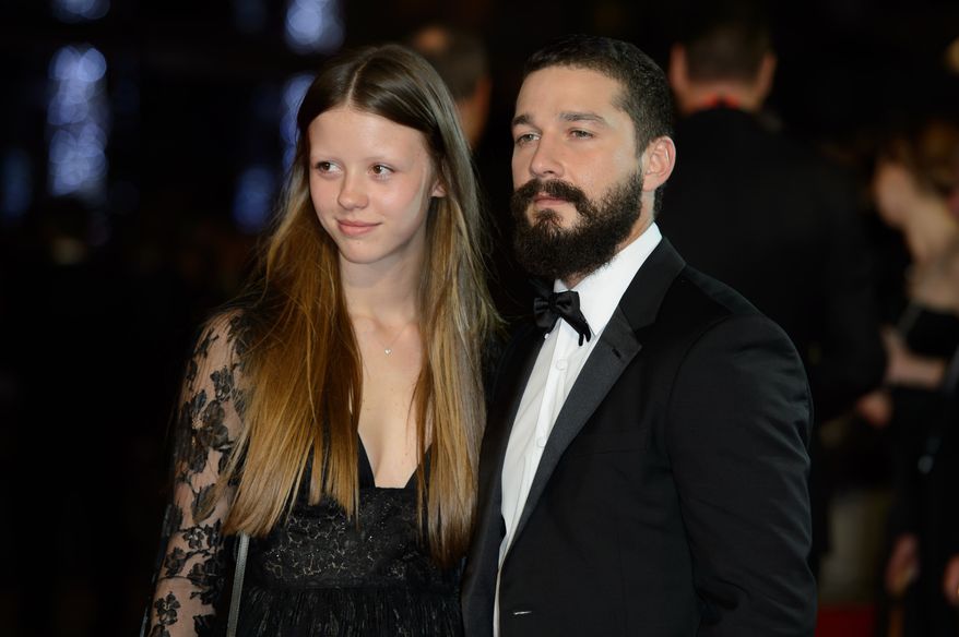 From left, Mia Goth and U.S actor Shia LaBeouf arrive for the premiere of Fury at a central London cinema, during the BFI London Film Festival, London, Sunday, Oct. 19, 2014. (Photo by Jonathan Short/Invision/AP)