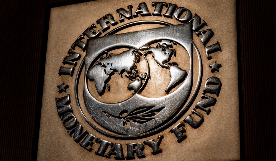 FILE - The logo of the International Monetary Fund is visible on its building, April 5, 2021, in Washington. (AP Photo/Andrew Harnik, File)