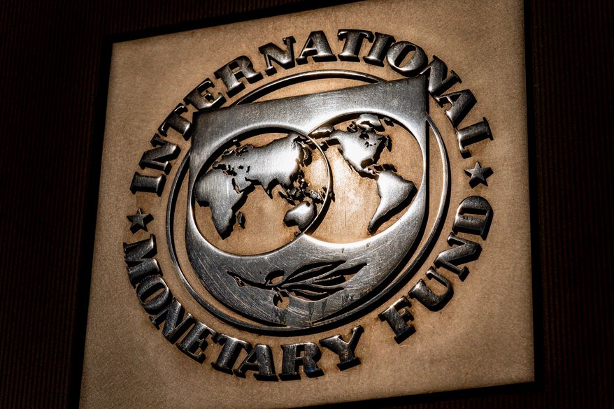 FILE - The logo of the International Monetary Fund is visible on its building, April 5, 2021, in Washington. (AP Photo/Andrew Harnik, File)