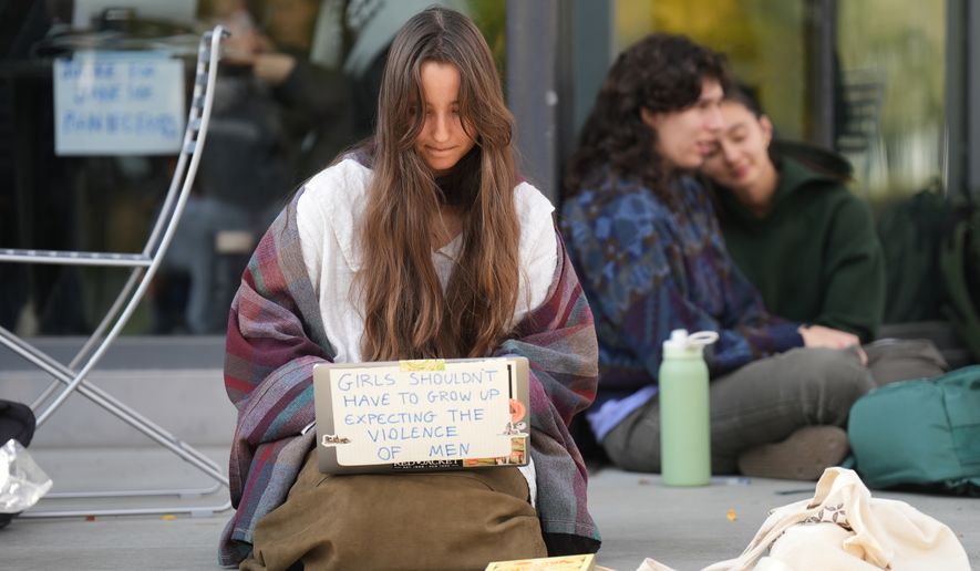 Student Isabel Breslin works on her laptop during a sit-in protest at Cornell University, Wednesday, Oct. 7, 2026, in Ithaca, N.Y. (AP Photo/Matt Burkhartt)