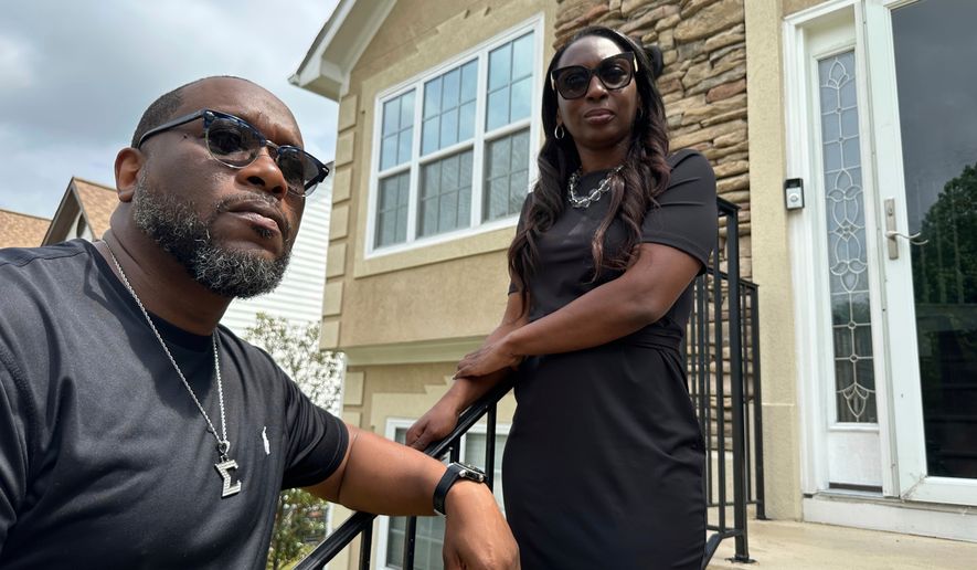 Toi Cliatt, left, and Trina Martin stand outside the home that the FBI mistakenly raided in 2017, on April 25, 2025, in Atlanta. (AP Photo/Sudhin Thanawala, File)