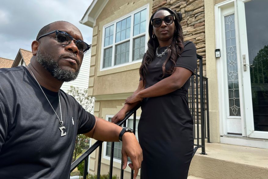 Toi Cliatt, left, and Trina Martin stand outside the home that the FBI mistakenly raided in 2017, on April 25, 2025, in Atlanta. (AP Photo/Sudhin Thanawala, File)