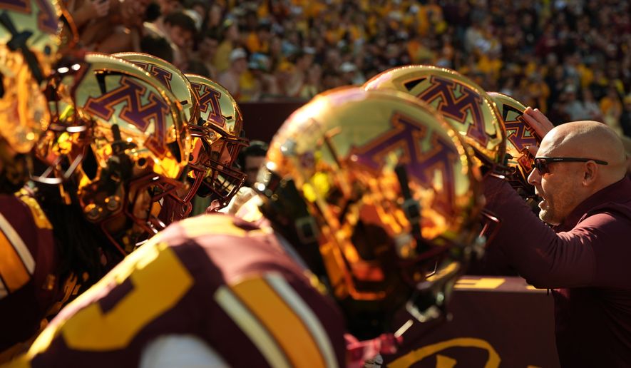 Minnesota head coach P.J. Fleck, right, hypes up his players before an NCAA college football game against Michigan, Saturday, Oct. 3, 2026, in Minneapolis. (AP Photo/Abbie Parr)