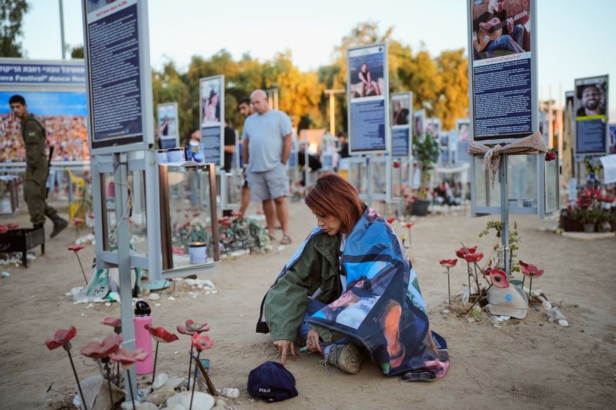 People mark the third anniversary of the Oct. 7, 2023, Hamas attack on Israel at the site of the Nova music festival, where hundreds of revelers were killed and abducted, near Kibbutz Reim, southern Israel, Wednesday, Oct. 7, 2026. (AP Photo/Ohad Zwigenberg)