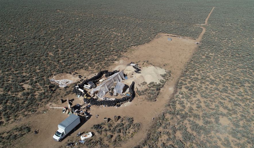FILE - An aerial view of a makeshift compound is seen in the desert area of Amalia, N.M., Aug. 10, 2018. (AP Photo/Brian Skoloff, File)