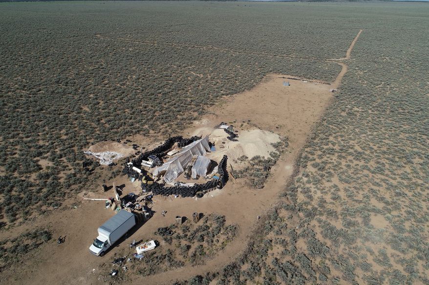 FILE - An aerial view of a makeshift compound is seen in the desert area of Amalia, N.M., Aug. 10, 2018. (AP Photo/Brian Skoloff, File)