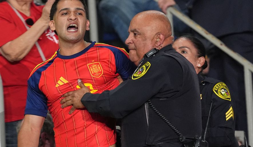 Police remove a protester as President Donald Trump speaks at a campaign rally at the Freeman Coliseum in San Antonio, Wednesday, Oct. 7, 2026. (AP Photo/Eric Gay)