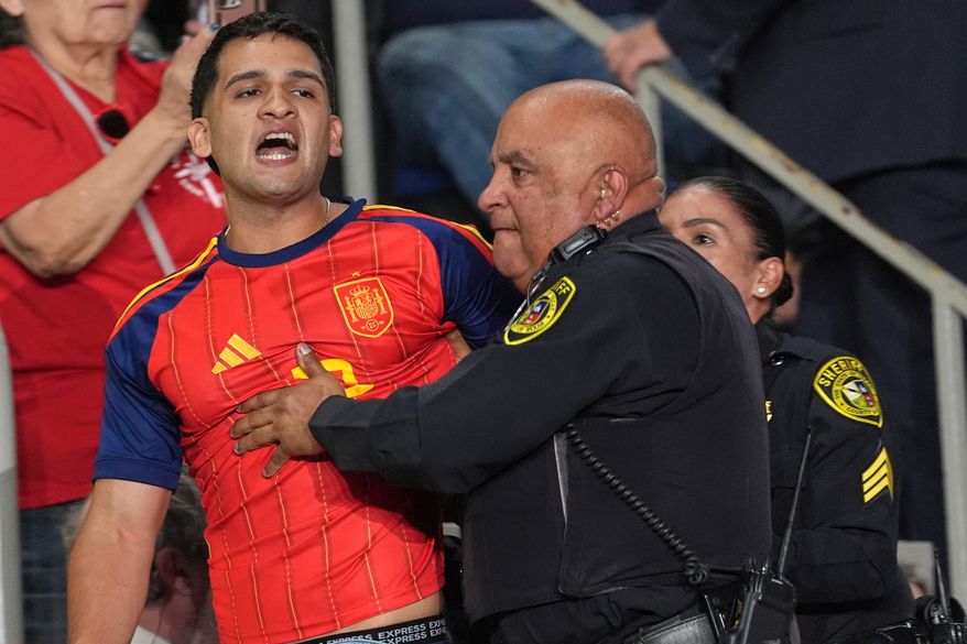 Police remove a protester as President Donald Trump speaks at a campaign rally at the Freeman Coliseum in San Antonio, Wednesday, Oct. 7, 2026. (AP Photo/Eric Gay)