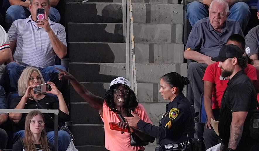 Police remove a protester as President Donald Trump speaks at a campaign rally at the Freeman Coliseum in San Antonio, Wednesday, Oct. 7, 2026. (AP Photo/Alex Brandon)