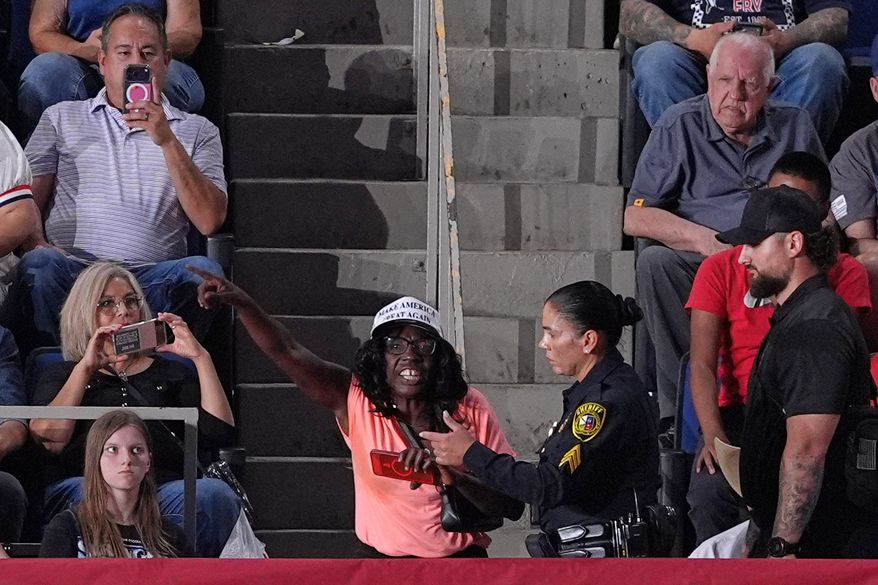 Police remove a protester as President Donald Trump speaks at a campaign rally at the Freeman Coliseum in San Antonio, Wednesday, Oct. 7, 2026. (AP Photo/Alex Brandon)
